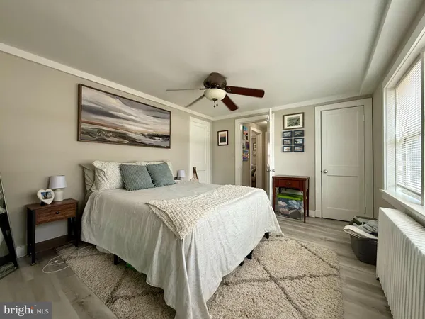 a spacious bedroom with a bed and a chandelier
