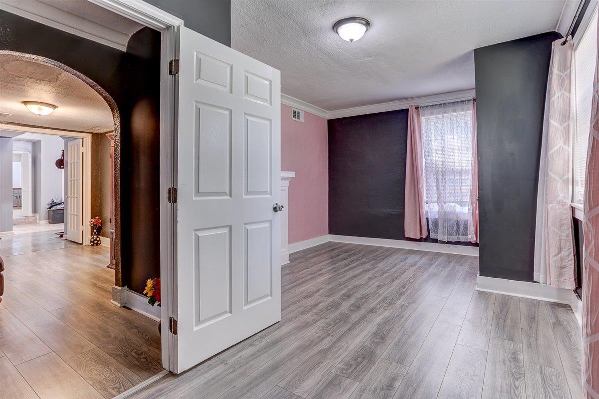 3700 Lakeview Road Memphis, TN 38116 - Photo 25 of 40 Hall featuring a textured ceiling, light wood-style floors, arched walkways, and crown molding