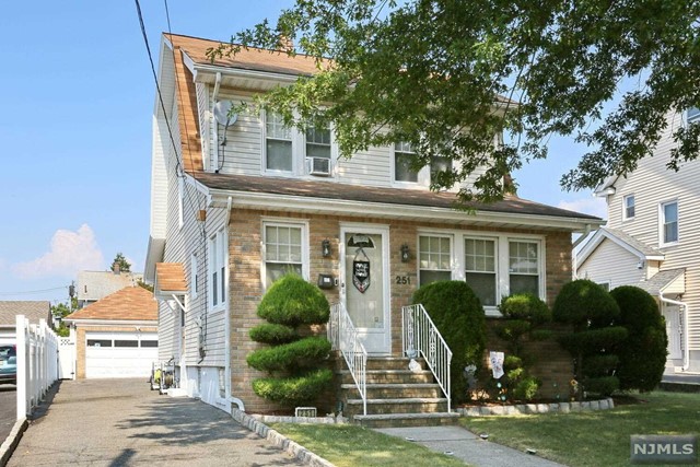251 Lawrence Avenue Hasbrouck Heights, NJ 07604 - Photo 1 of 35 a front view of a house with garden and plants