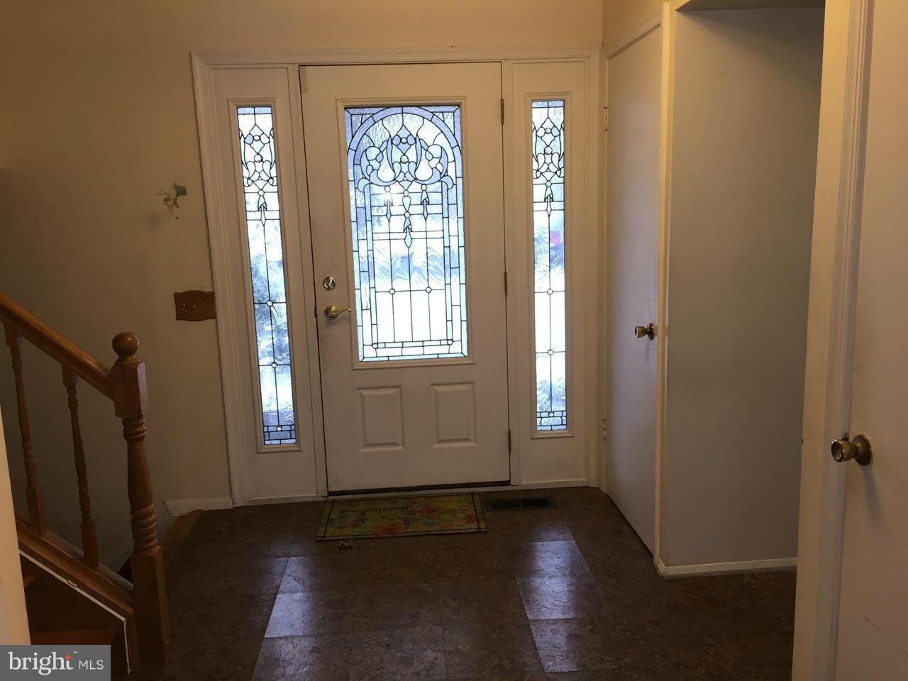 2 Countryside Court Silver Spring, MD 20905 - Photo 3 of 6 an empty room with wooden floor and windows