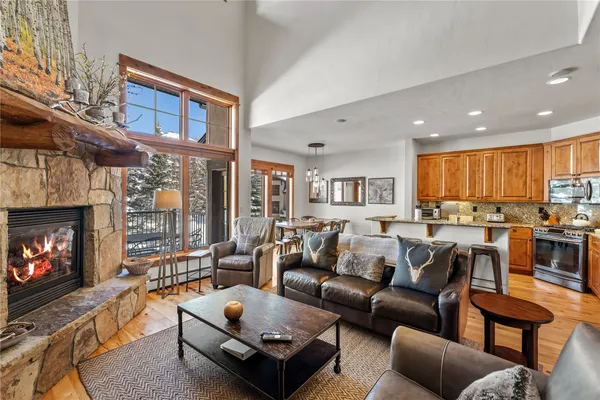 a living room with furniture a fireplace a flat screen tv and a window
