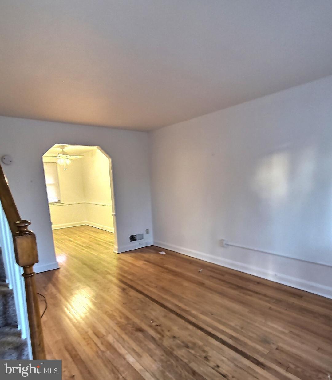 2820 Edgecombe Circle South Baltimore, MD 21215 - Photo 3 of 14 a view of empty room with wooden floor and fan