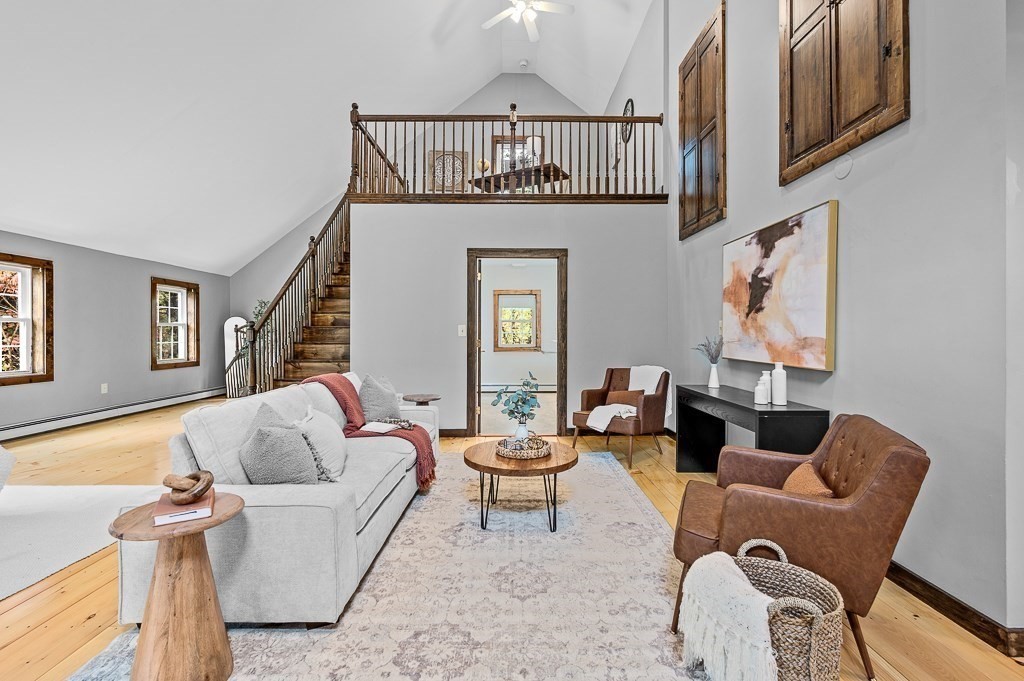 46 Farm Road Bolton, MA 01740 - Photo 14 of 41 a living room with furniture a window and a chandelier