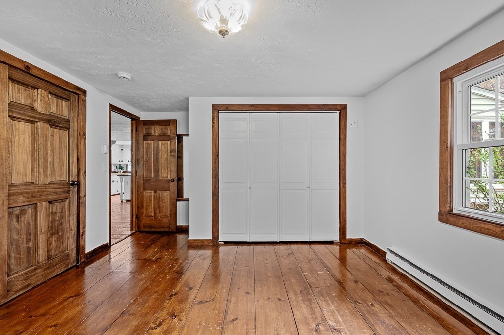 46 Farm Road Bolton, MA 01740 - Photo 24 of 41 a view of empty room with wooden floor and fan