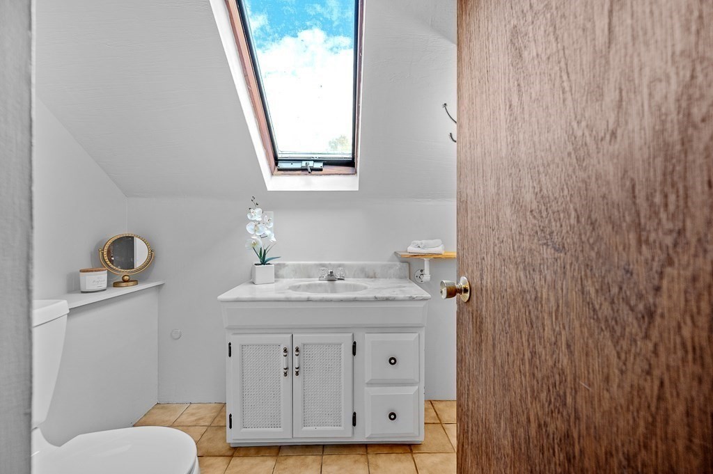 46 Farm Road Bolton, MA 01740 - Photo 27 of 41 a bathroom with a granite countertop sink toilet and mirror