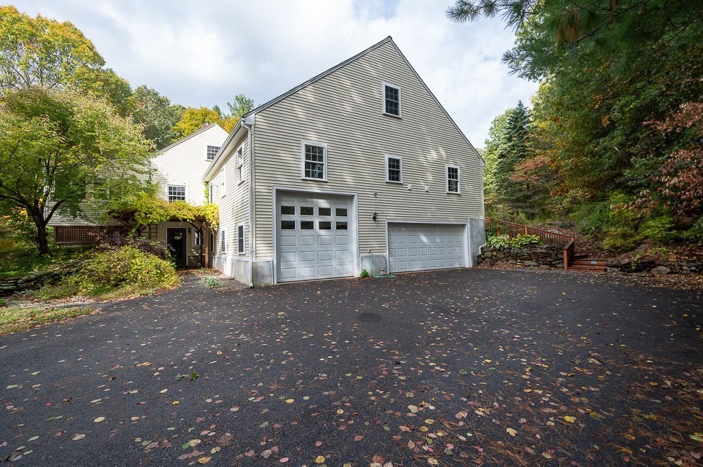 46 Farm Road Bolton, MA 01740 - Photo 33 of 41 a view of a house with a yard and garage