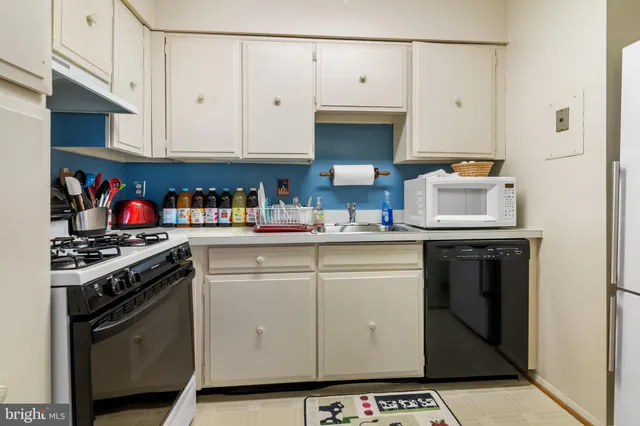 a kitchen with stainless steel appliances a stove a microwave and cabinets