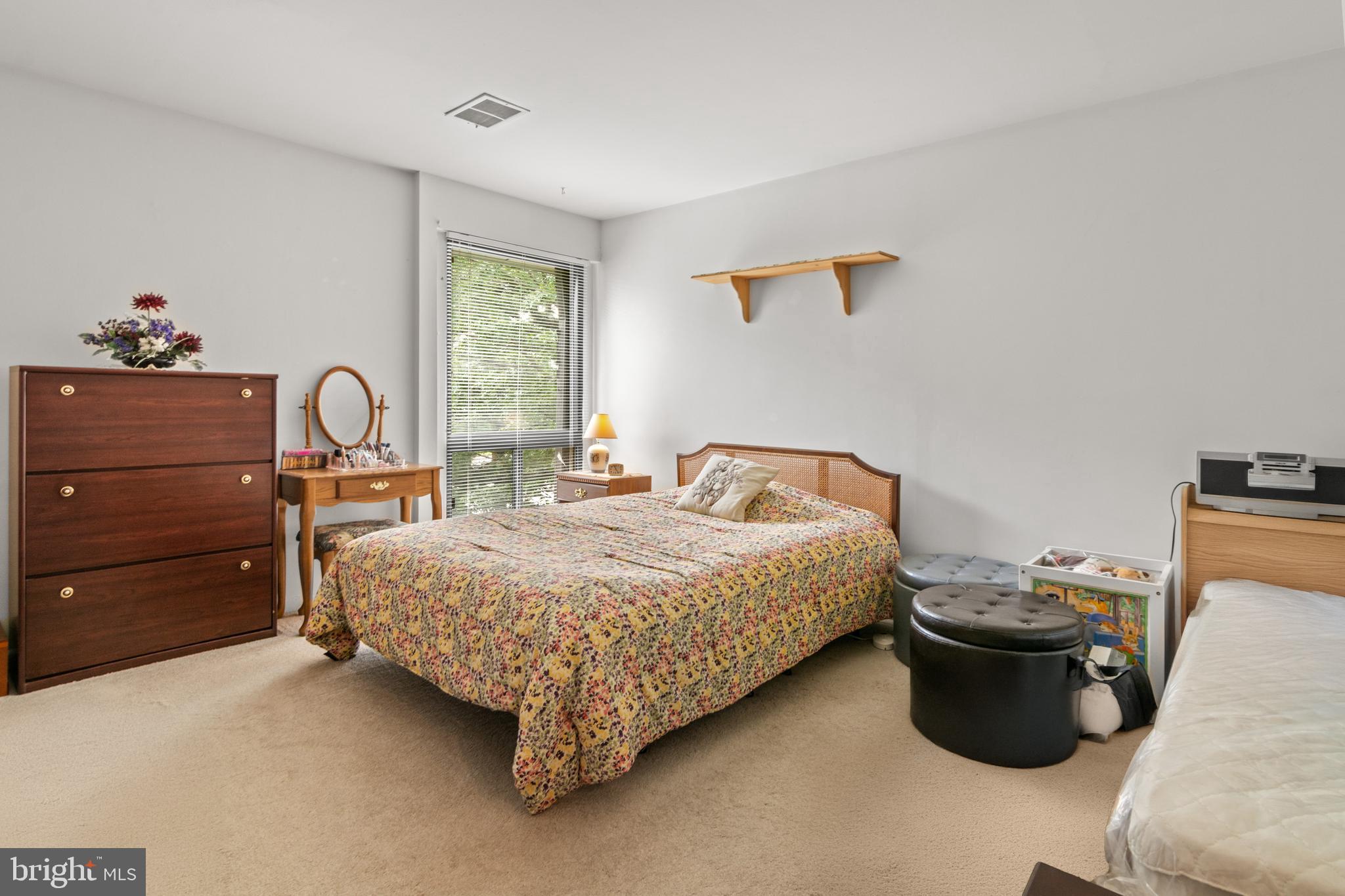 9800 Georgia Avenue, Unit 25301 Silver Spring, MD 20902 - Photo 15 of 22 a bedroom with a bed and a table