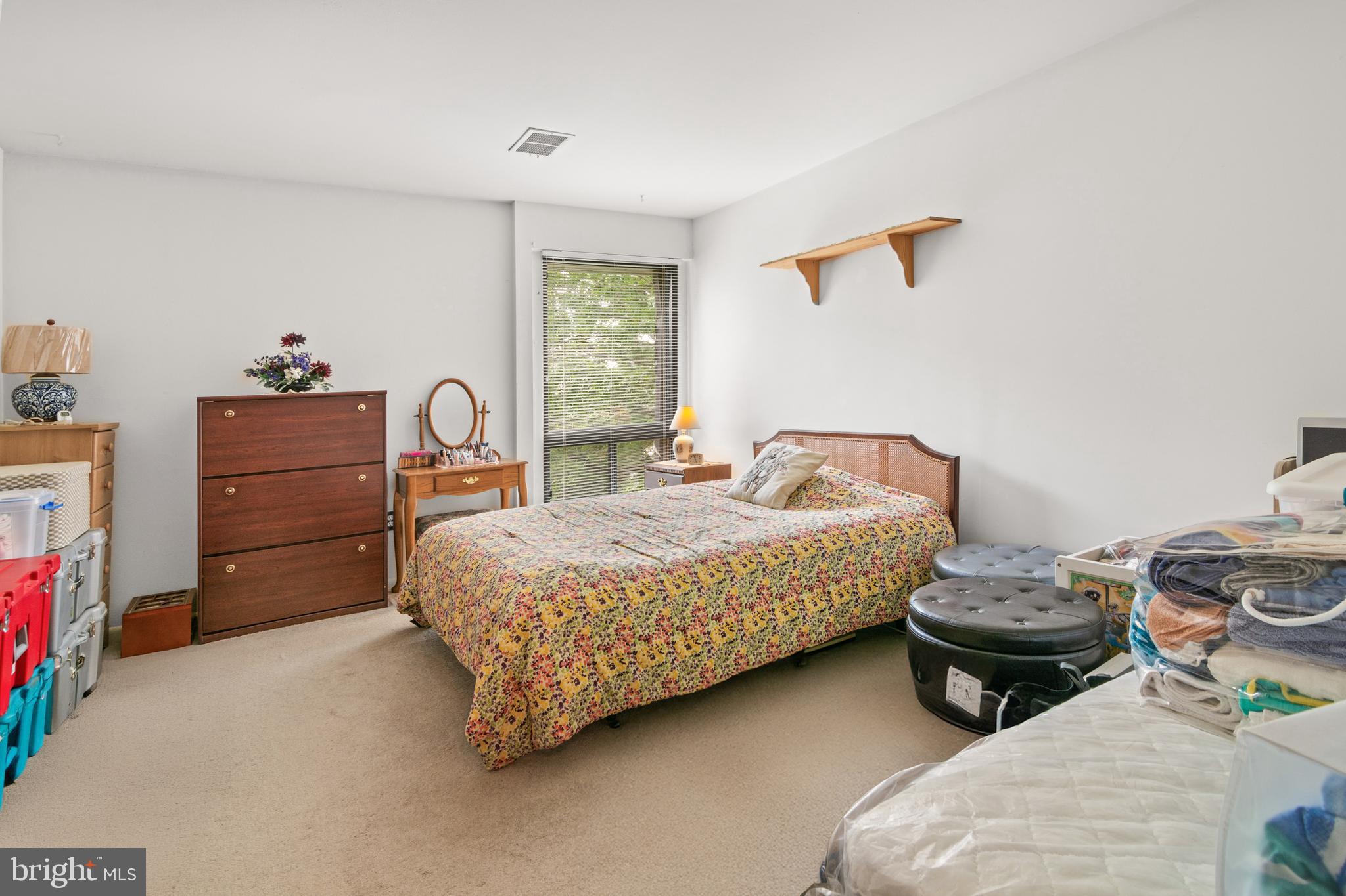 9800 Georgia Avenue, Unit 25301 Silver Spring, MD 20902 - Photo 18 of 22 a bedroom with a bed and a dresser