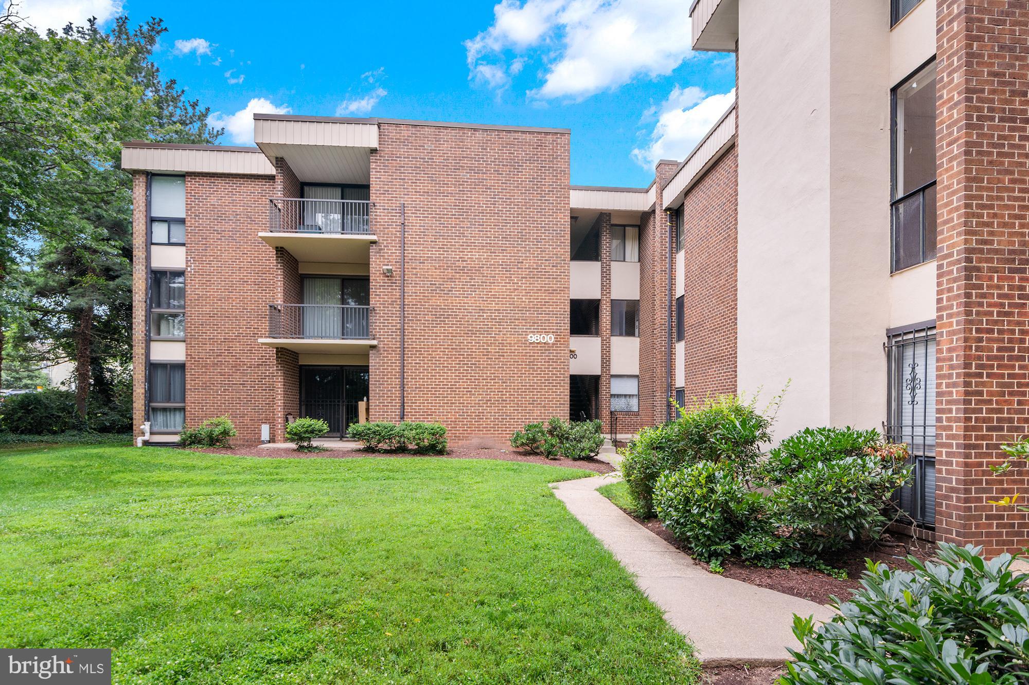 9800 Georgia Avenue, Unit 25301 Silver Spring, MD 20902 - Photo 3 of 22 a front view of a house with garden and trees