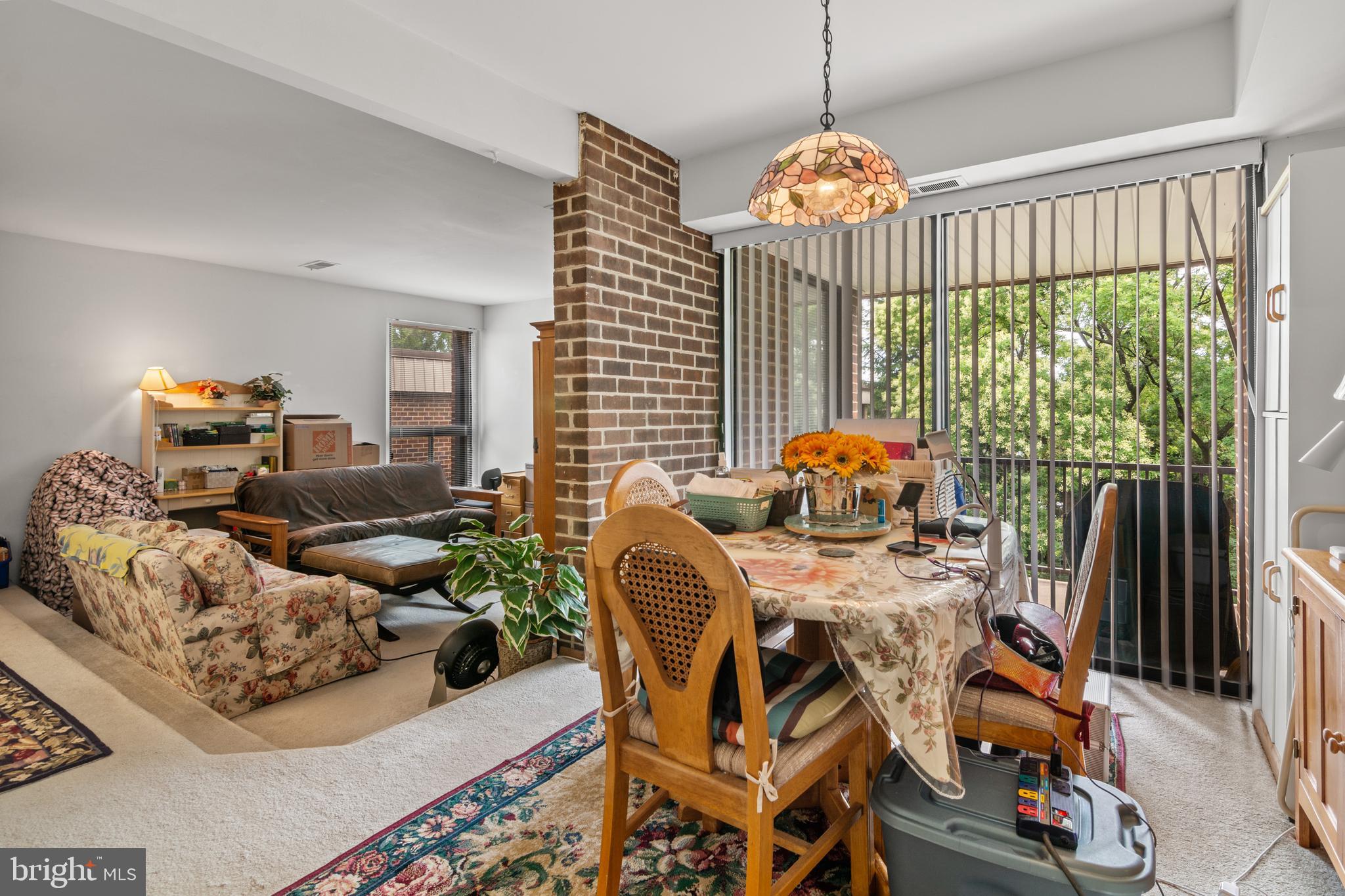 9800 Georgia Avenue, Unit 25301 Silver Spring, MD 20902 - Photo 10 of 22 a living room with furniture a chandelier and a large mirror