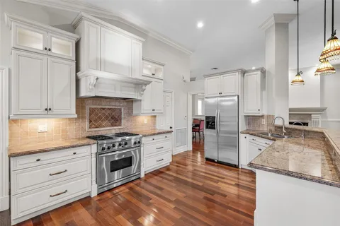 a kitchen with granite countertop cabinets stainless steel appliances and a counter space