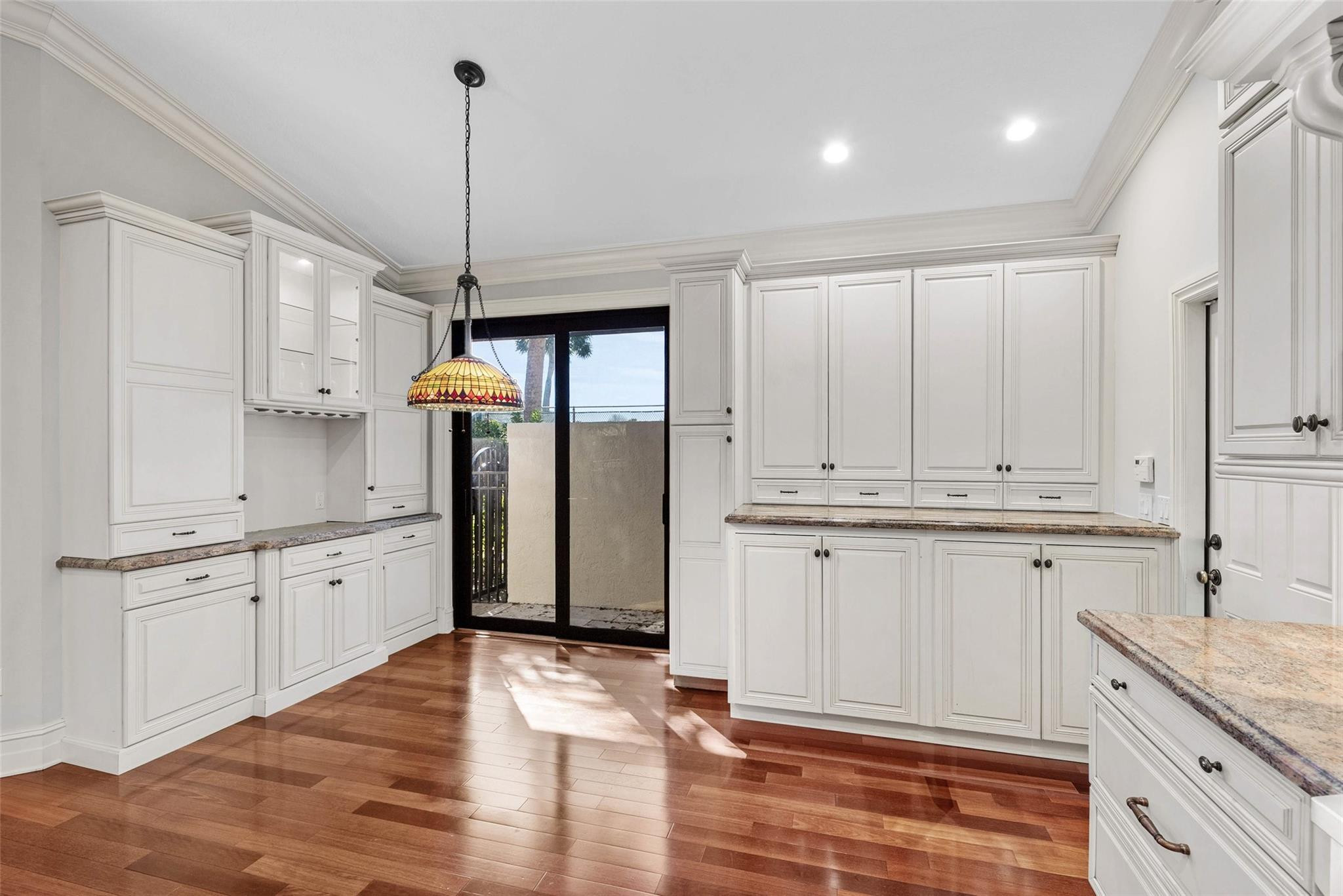 2455 Hampton Bridge Road Delray Beach, FL 33445 - Photo 12 of 46 a kitchen with granite countertop white cabinets white appliances and granite counter tops