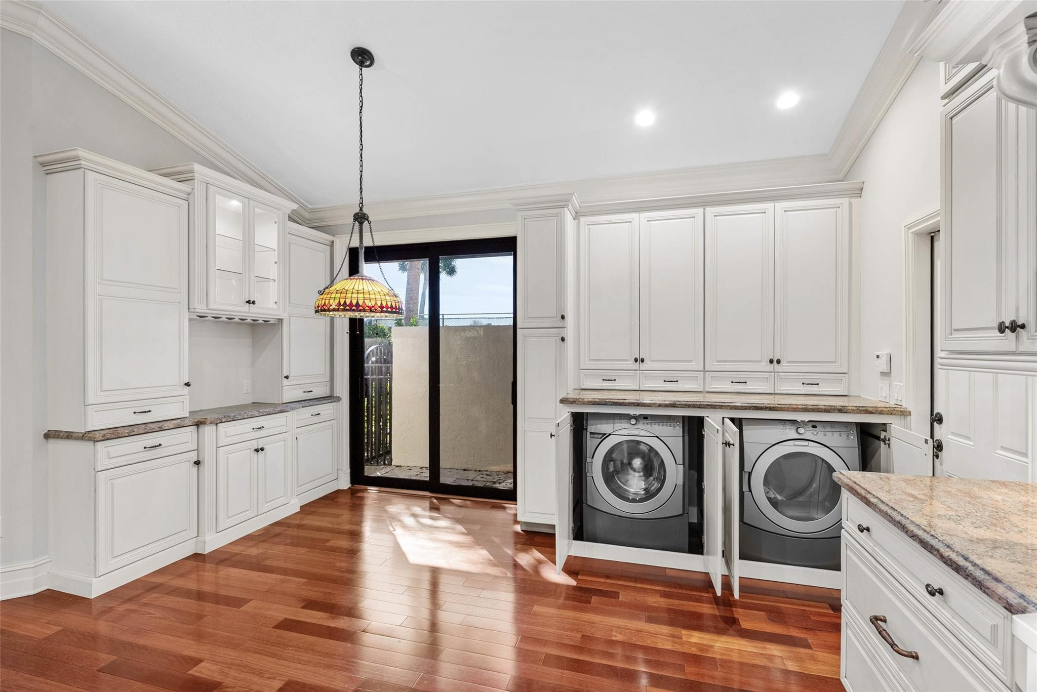 2455 Hampton Bridge Road Delray Beach, FL 33445 - Photo 13 of 46 a kitchen with stainless steel appliances granite countertop a refrigerator a stove and white cabinets with wooden floors