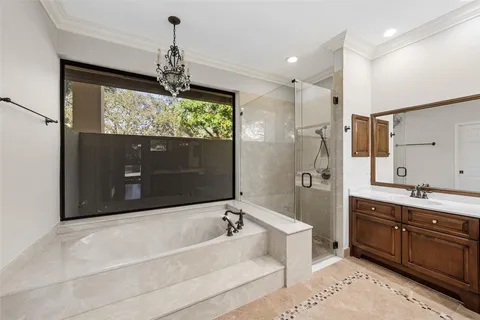 a spacious bathroom with a tub sink shower and mirror