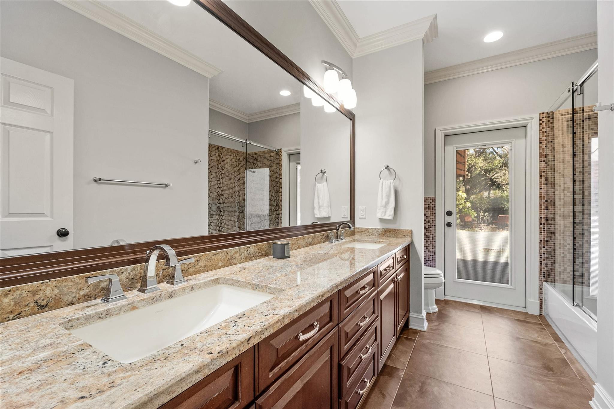 2455 Hampton Bridge Road Delray Beach, FL 33445 - Photo 24 of 46 a spacious bathroom with a granite countertop double vanity sink a mirror and a bathtub