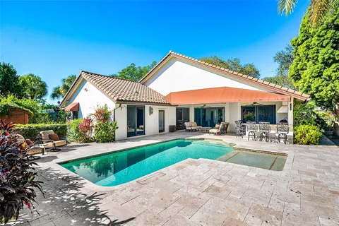 a view of a house with backyard and sitting area