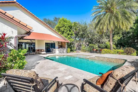 a view of a swimming pool with chair and tables