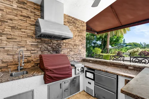 a view of outdoor sitting area with furniture and umbrella