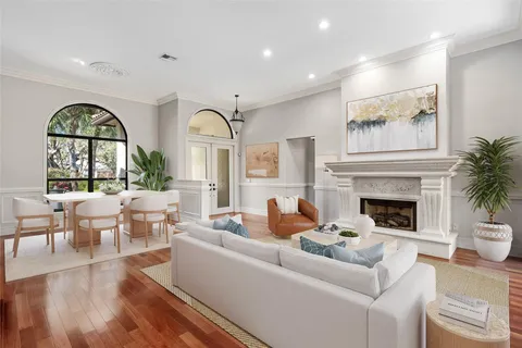 a living room with furniture a fireplace and a large window with outer view