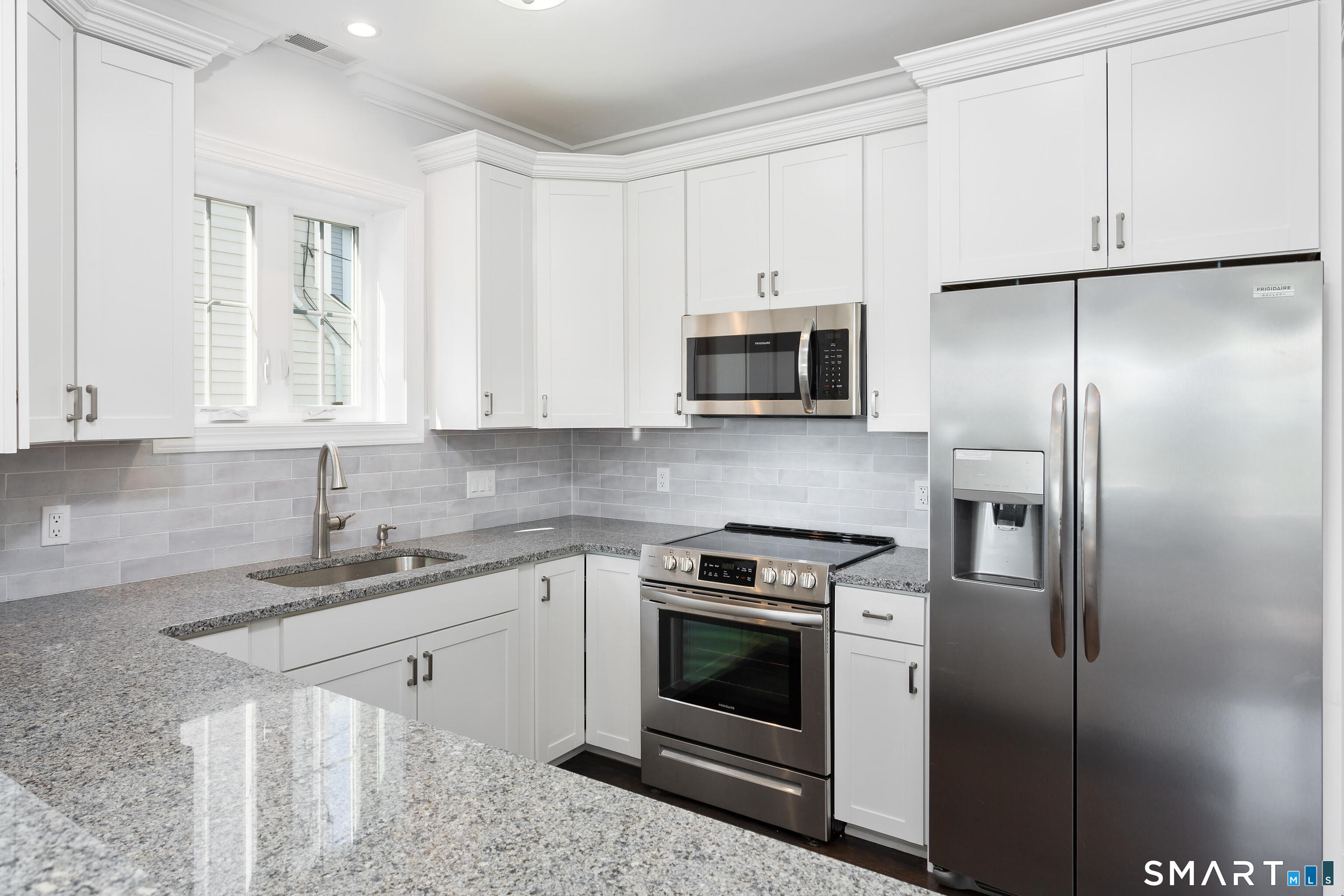 930 Reef Road Fairfield, CT 06824 - Photo 5 of 15 a kitchen with stainless steel appliances granite countertop a refrigerator sink and stove
