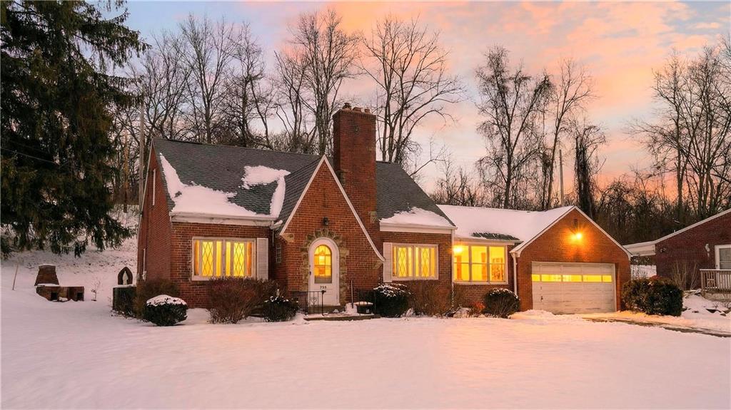 a view of a house with a yard covered in snow