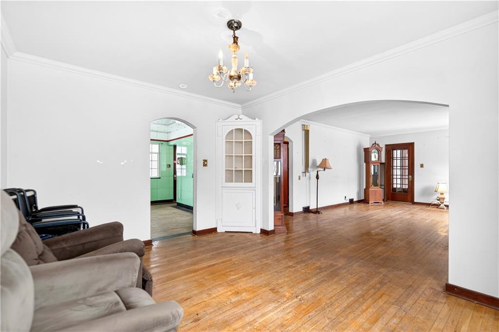 746 McNeilly Road Pittsburgh, PA 15226 - Photo 11 of 47 a view of a livingroom with a furniture chandelier and wooden floor