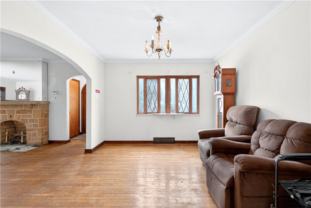 746 McNeilly Road Pittsburgh, PA 15226 - Photo 13 of 47 a living room with furniture a fireplace and a chandelier