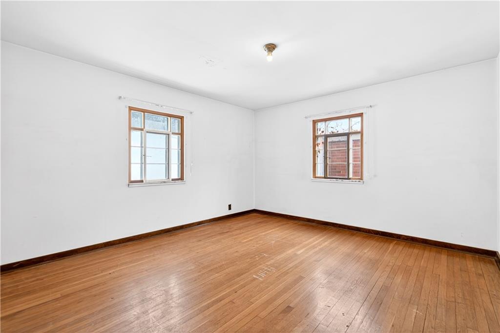 746 McNeilly Road Pittsburgh, PA 15226 - Photo 18 of 47 an empty room with wooden floor and windows