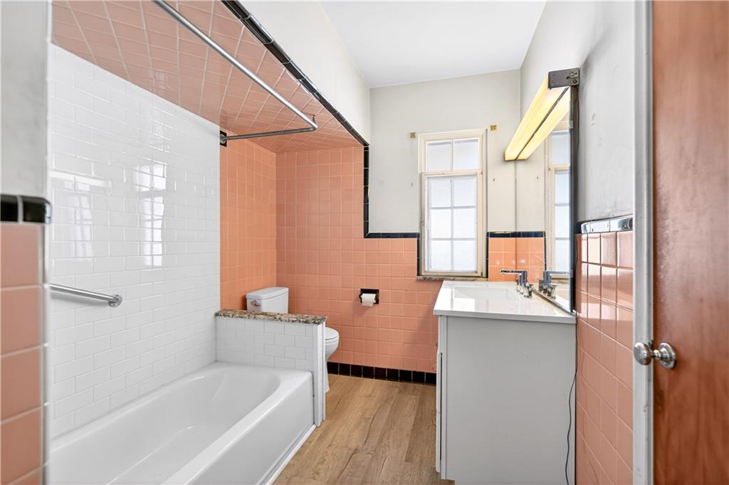 746 McNeilly Road Pittsburgh, PA 15226 - Photo 20 of 47 a bathroom with a granite countertop sink mirror bathtub and shower