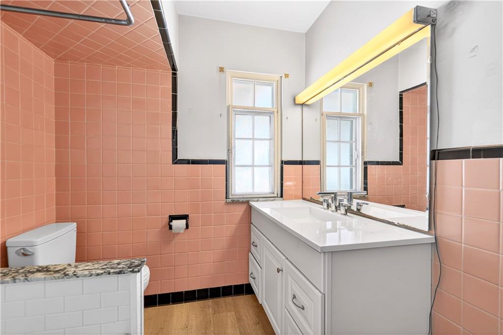 746 McNeilly Road Pittsburgh, PA 15226 - Photo 21 of 47 a bathroom with a double vanity sink a mirror and a bathtub