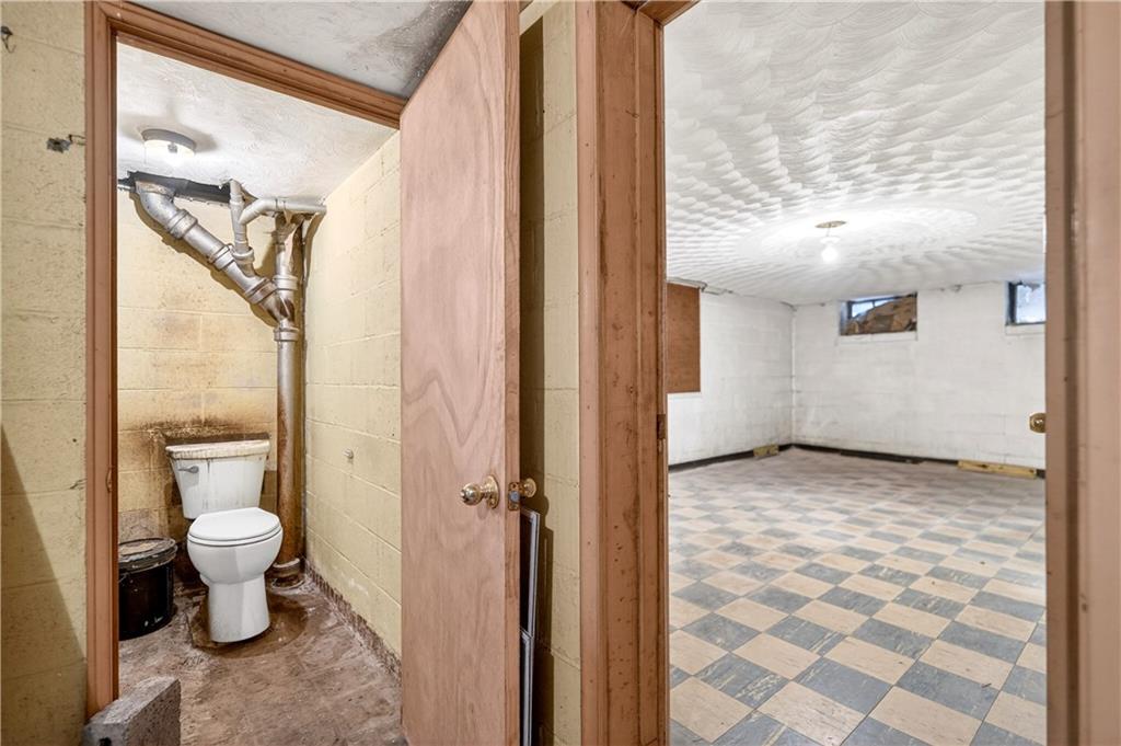 746 McNeilly Road Pittsburgh, PA 15226 - Photo 32 of 47 a bathroom with a granite countertop sink a toilet and a mirror