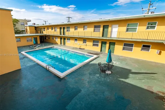 a front view of a building with two chairs