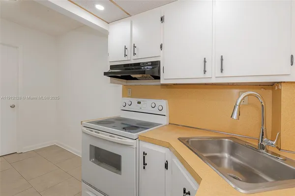a kitchen with a sink and refrigerator