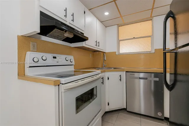 a kitchen with a refrigerator and a sink