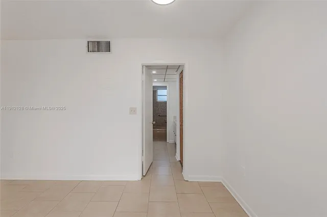 a kitchen with white cabinets sink and white appliances