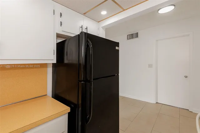 a kitchen with a stove cabinets and a refrigerator