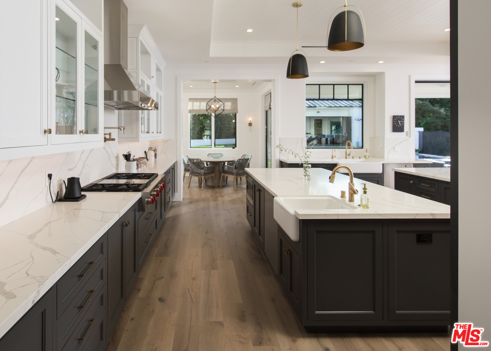 16656 Oldham Street Encino, CA 91436 - Photo 11 of 46 a kitchen with a sink and a stove top oven