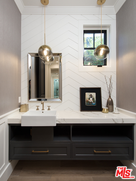 16656 Oldham Street Encino, CA 91436 - Photo 14 of 46 a bathroom with a sink and a mirror