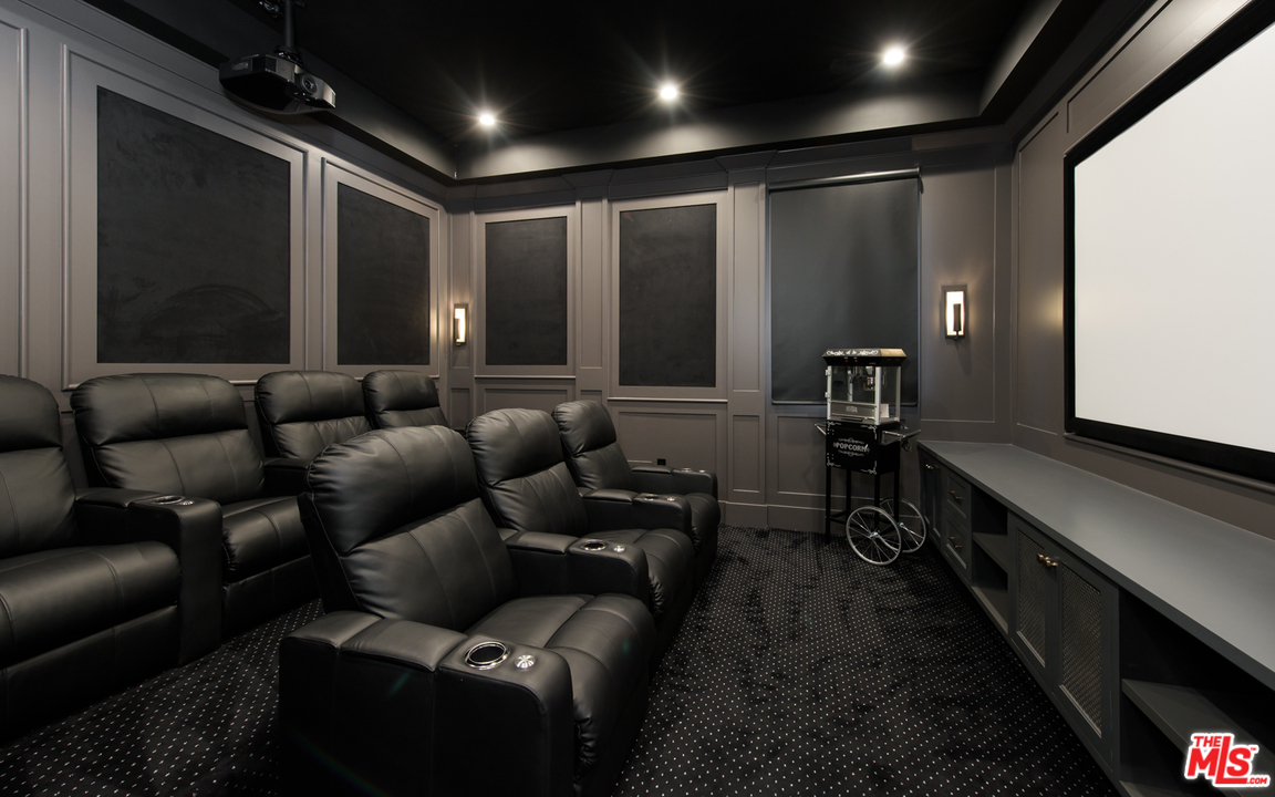 16656 Oldham Street Encino, CA 91436 - Photo 16 of 46 a media room with lots of chairs and a projector