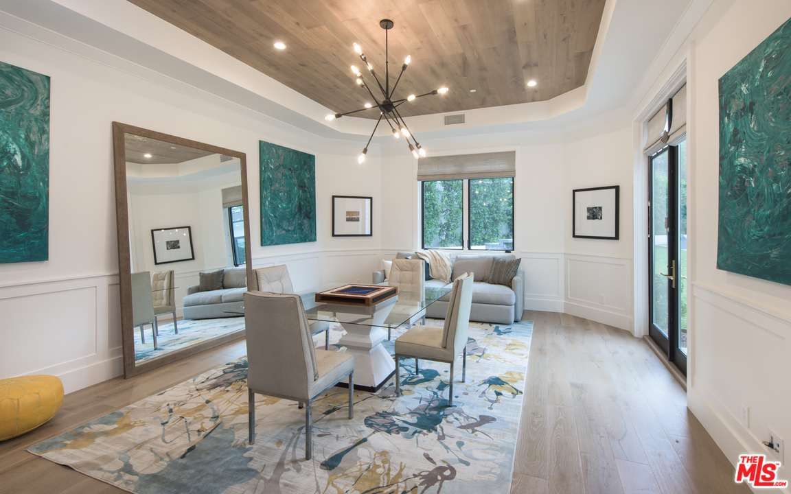 16656 Oldham Street Encino, CA 91436 - Photo 17 of 46 a living room with furniture a chandelier and a dining table