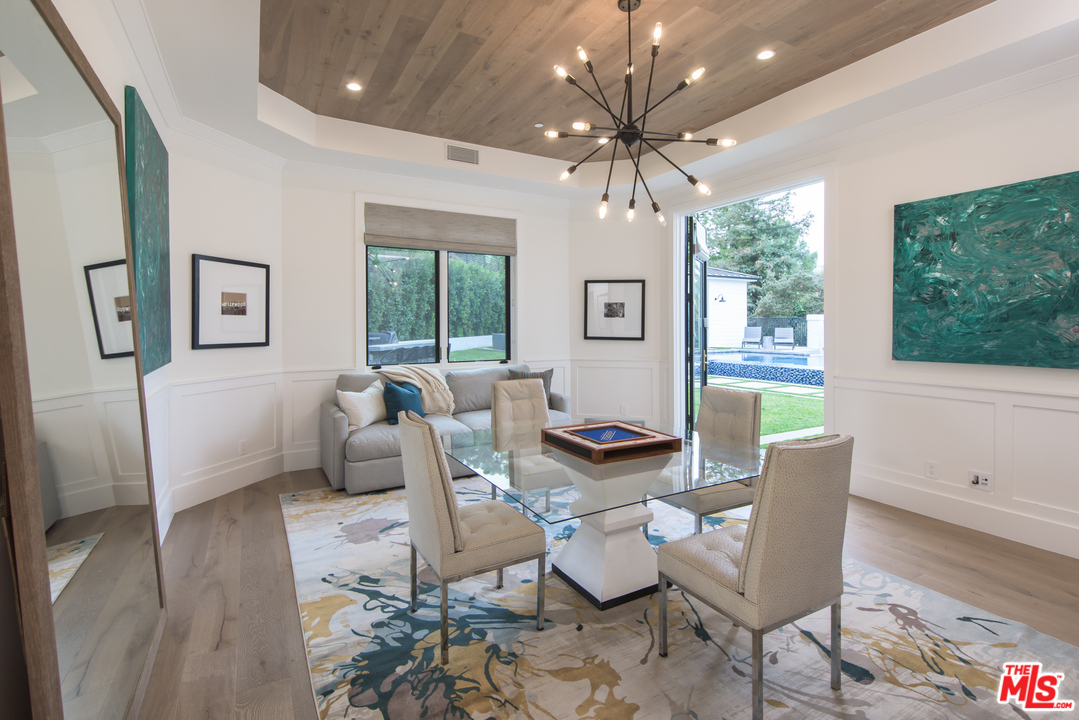 16656 Oldham Street Encino, CA 91436 - Photo 18 of 46 a living room with furniture and a chandelier