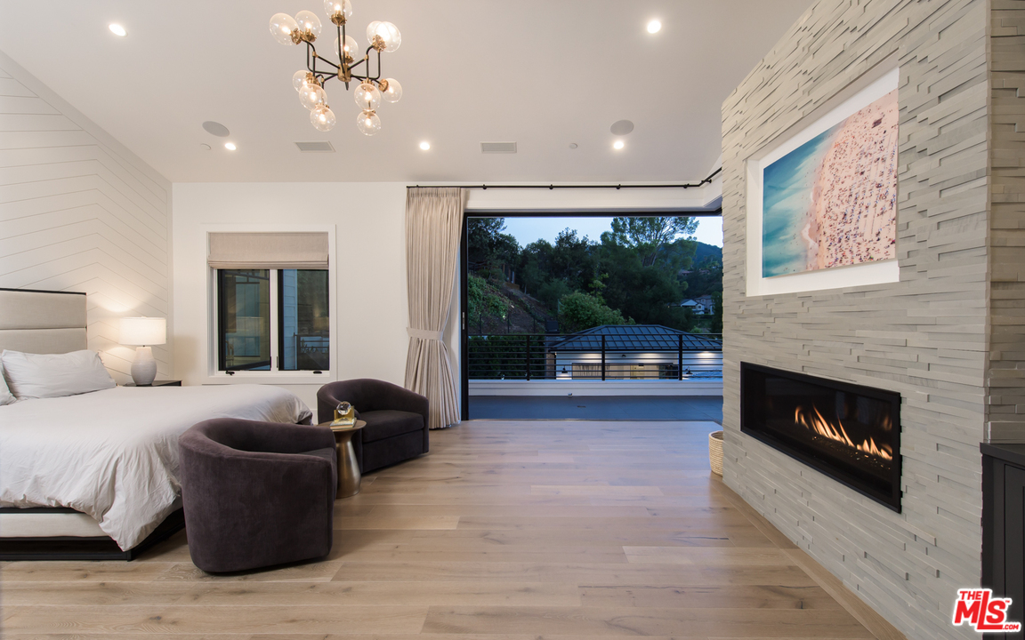 16656 Oldham Street Encino, CA 91436 - Photo 21 of 46 a bedroom with furniture and a fireplace