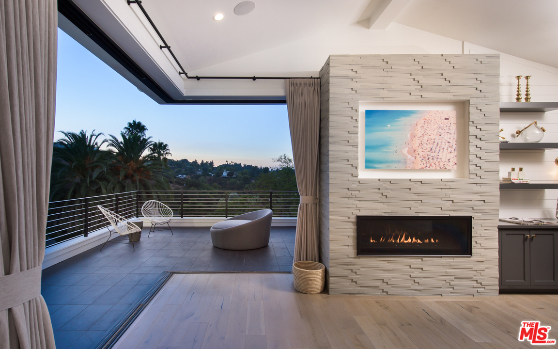 16656 Oldham Street Encino, CA 91436 - Photo 23 of 46 a living room with furniture wooden floor and a fireplace