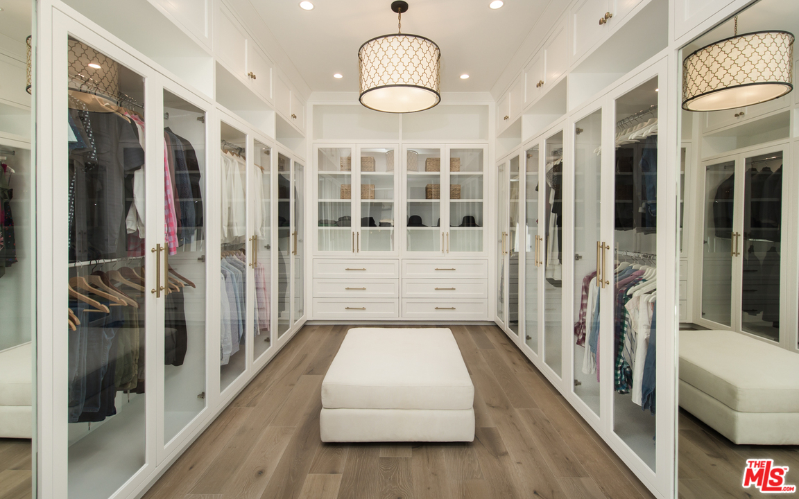 16656 Oldham Street Encino, CA 91436 - Photo 28 of 46 a hallway with white walls and chandelier