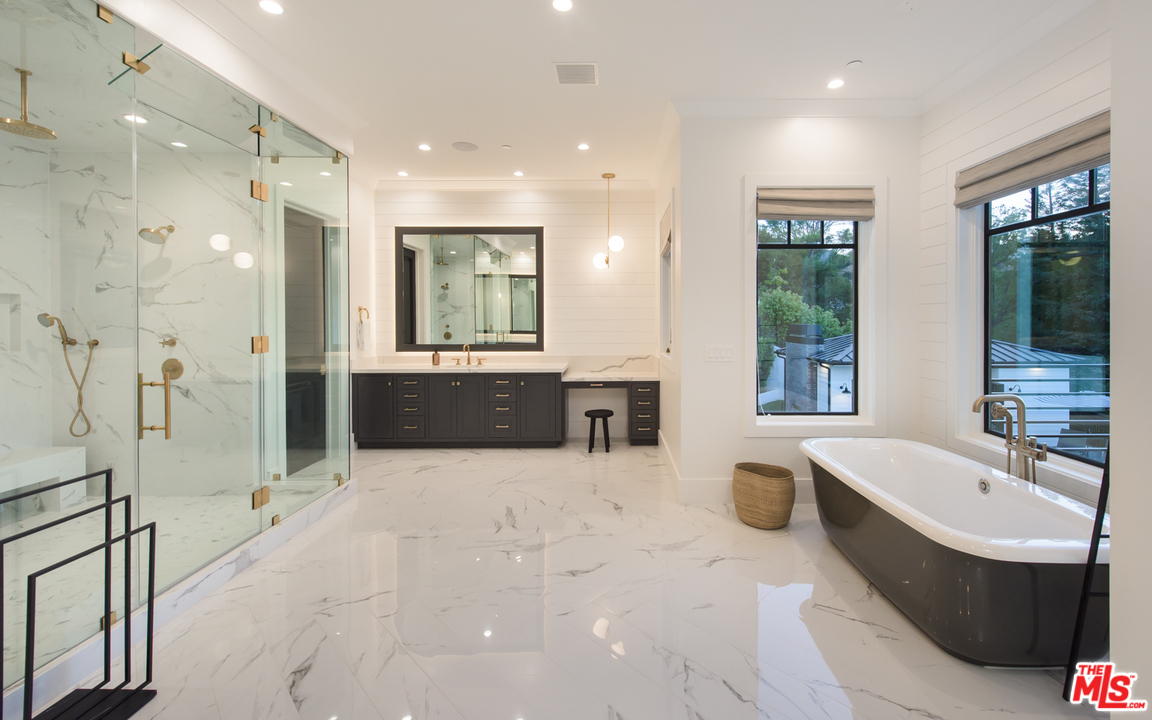 16656 Oldham Street Encino, CA 91436 - Photo 29 of 46 a spacious bathroom with a tub sink shower and mirror