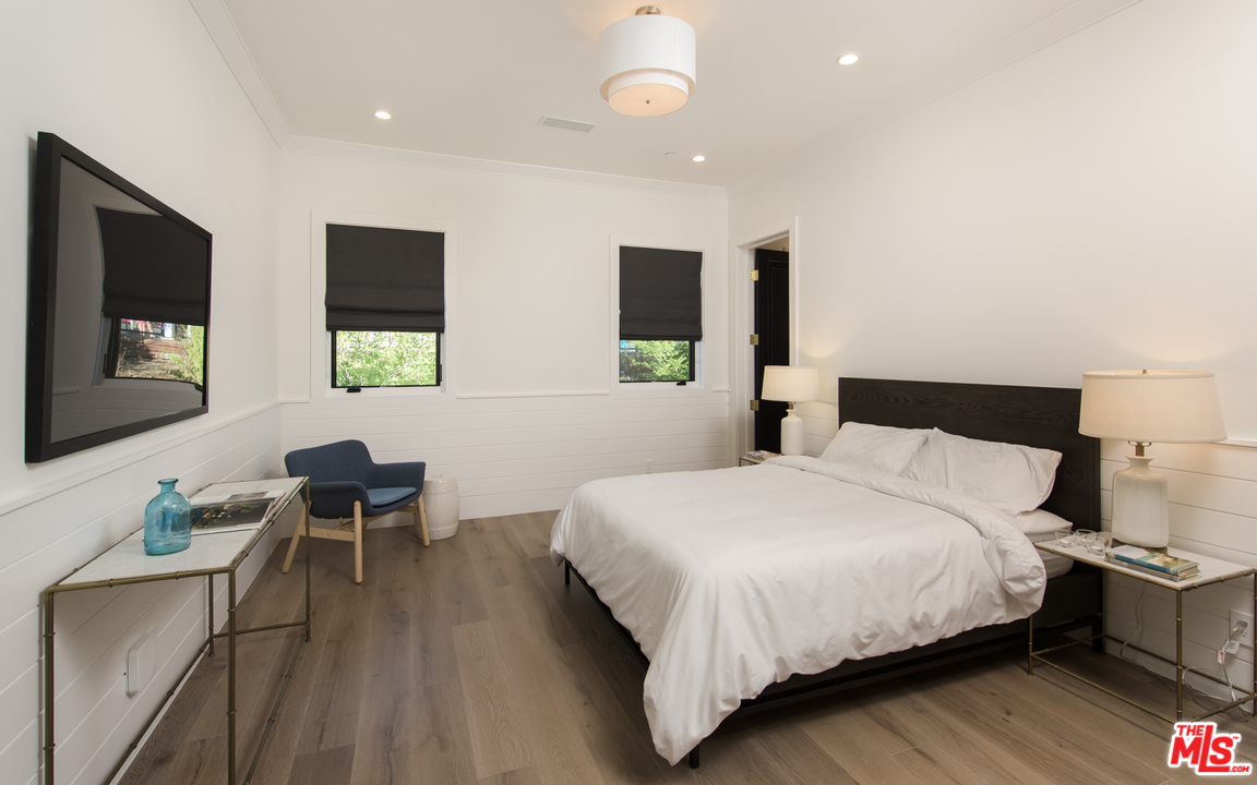 16656 Oldham Street Encino, CA 91436 - Photo 33 of 46 a bedroom with two beds and a flat screen tv