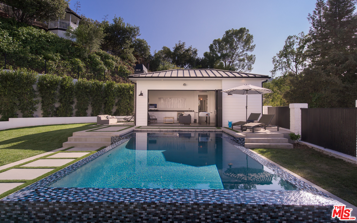 16656 Oldham Street Encino, CA 91436 - Photo 38 of 46 a view of a swimming pool with a patio