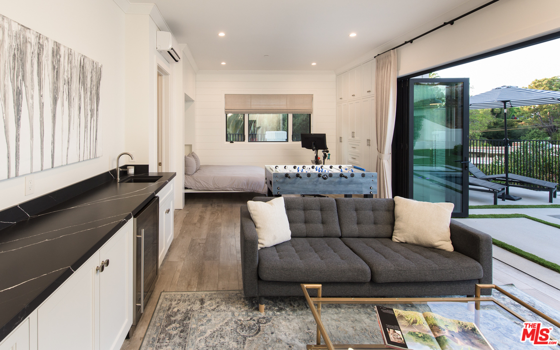 16656 Oldham Street Encino, CA 91436 - Photo 39 of 46 a living room with furniture and a large window