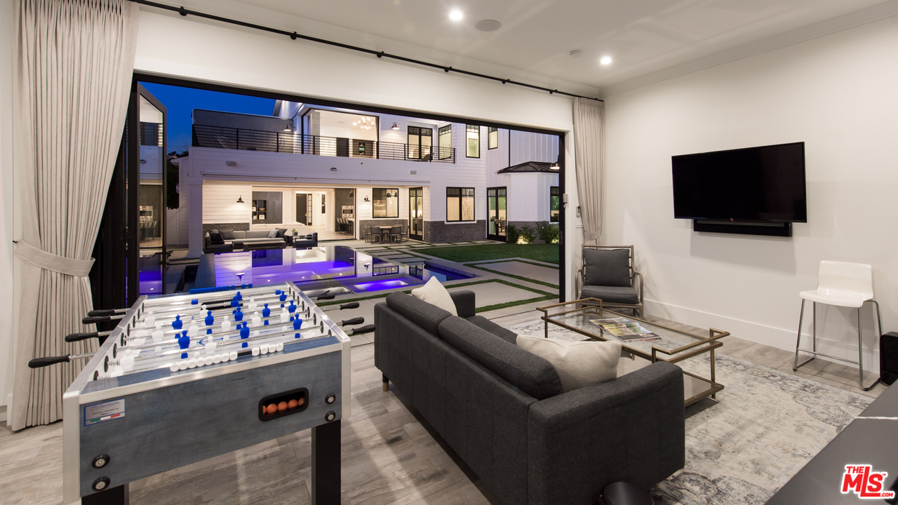 16656 Oldham Street Encino, CA 91436 - Photo 41 of 46 a living room with furniture and a flat screen tv